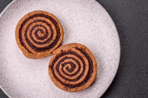 Freshly baked cinnamon roll with spices and cocoa filling photo