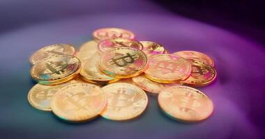 Bitcoin coins on a purple background video