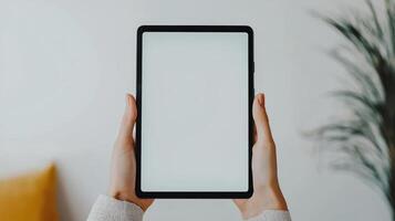 Hands touching the blank screen of a black tablet computer, isolated on a white background. photo