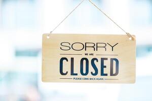 Closed sign on a cafe door, signaling the end of a business day with a polite message. photo