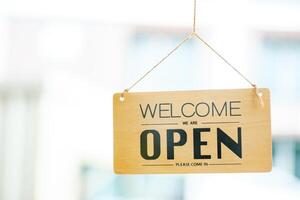 Open sign welcoming customers, symbolizing the beginning of a new business day. photo