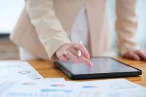 Close-up of hand signing electronic documents on a tablet with a digital pen for online workflows photo