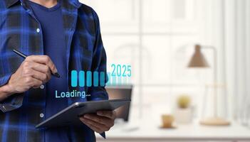 A man is holding a tablet with a line of data on it photo