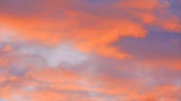 A plane flying in the sky with a red and orange sky photo