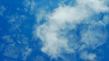 A plane flying through the sky with clouds photo