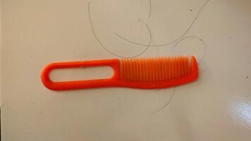 A comb is sitting on a white counter photo