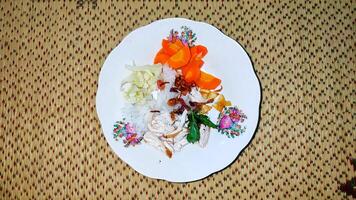 A plate with food on it and a picture of a bird photo