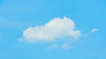 A plane flying in the sky with a cloud in the background photo