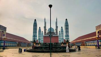 The mosque is in the middle of a courtyard photo