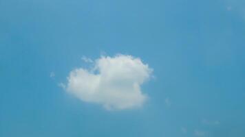 A plane flying in the sky with a cloud in the background photo