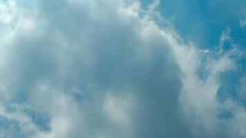 A plane flying in the sky with a cloud in the background photo
