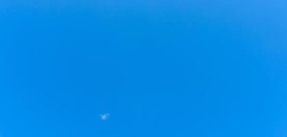 Beautiful blue sky without clouds in the morning or evening used as natural background texture in decorative art work photo