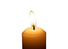 A single burning candle flame or light glowing on a big white candle isolated on white background with clipping path photo
