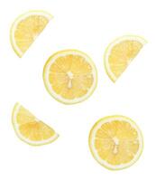 Top view set of fresh yellow lemon fruit in halves and slices or quarter scattering isolated on white background with clipping path photo