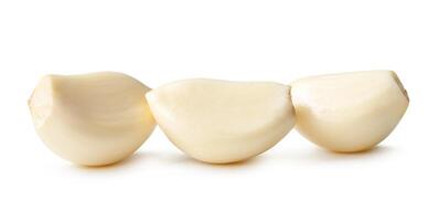 Side view of peeled garlic cloves in stack isolated on white background with clipping path photo