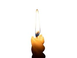 A single burning candle flame or light glowing on a small spiral white candle isolated on white background with clipping path photo