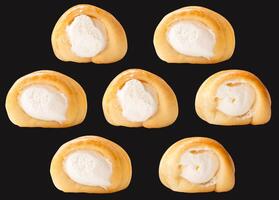 Top view set of puff pastry cream horns isolated on black background with clipping path photo