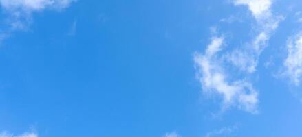 Low angle view of beautiful blue sky with strange shape of clouds in the morning or evening used as natural background texture in decorative art work. photo