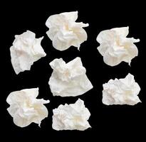 Top view set of screwed or crumpled white tissue paper ball isolated on black background with clipping path photo