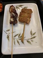 Yakitori, a traditional Japanese dish featuring skewered chicken grilled to perfection. Enjoy tender, flavorful bites with classic yakitori sauce. Ideal for street food photo
