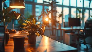 dawn breaks through skyscrapers in office, desk lamp on in foreground. concept work till dawn photo
