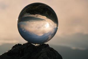 The landscape view on a nature through a glass ball with a blurred background creative photography photo