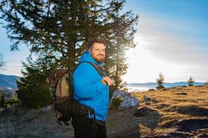 A happy man backpacker trail hiking on the mountain forest adventure travel active lifestyle. photo