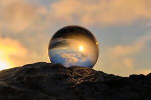 The landscape view on a nature through a glass ball with a blurred background creative photography photo