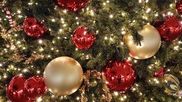 A close-up of a Christmas tree adorned with red ornaments and white lights. The tree is covered in a light dusting of artificial snow, creating a festive and magical atmosphere photo