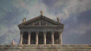 Ancient temple structure with statues under a cloudy sky during sunset video