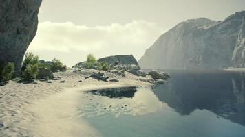 Scenic view of a tranquil beach with a rocky coastline in Portugal video