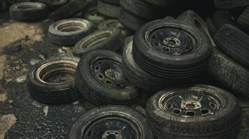 Old and worn tires scattered on a roadside in an abandoned area at dusk video