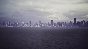 A panoramic view of a city skyline silhouetted against a cloudy sky video