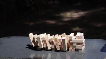 Jenga tower collapses in slow motion capturing the suspense and thrill of the game video