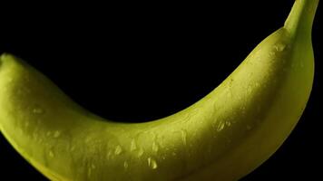 Wet banana rotates on isolated background video