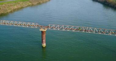 A rusty metal pipe across the river video