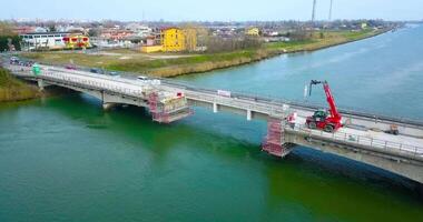 A bridge over the river with a part under construction video