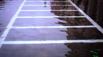 Flood water wave rolls on automobile parking lot marking video