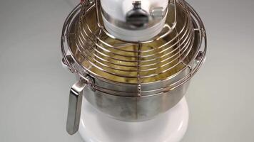 Machine mixes raw dough for delicious cake on white table video