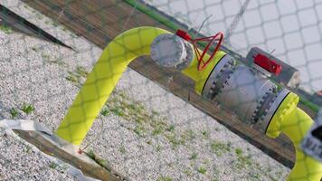 A big yellow pipe behind a mesh fence video