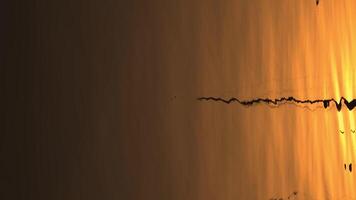 Reflections of the pole in the water at sunset video