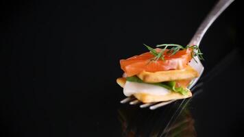 small snack canapes with crackers and lightly salted red fish Salmon, isolated on black background video