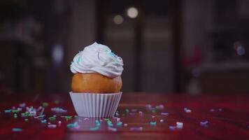 Cake with cream on top is covered with coconut flakes video