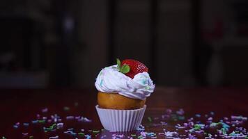 Strawberry falls in slow motion on a cake with cream video