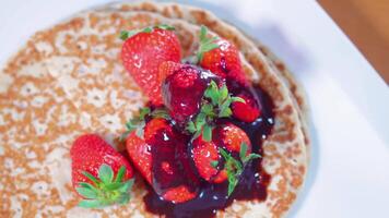 Strawberries with syrup on top on pancakes video