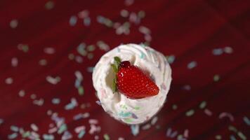 Red syrup poured in slow motion on the cake with cream and strawberry video