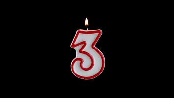 Candle in the shape of the number THREE on a black background video