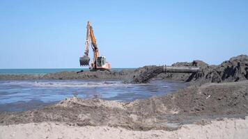 Sliding mud in slow motion from a pipe on the beach video