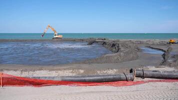 work in progress on the beach to move the sand with pressure pipes video
