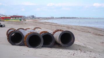 Four tubes resting on the sand of the beach video